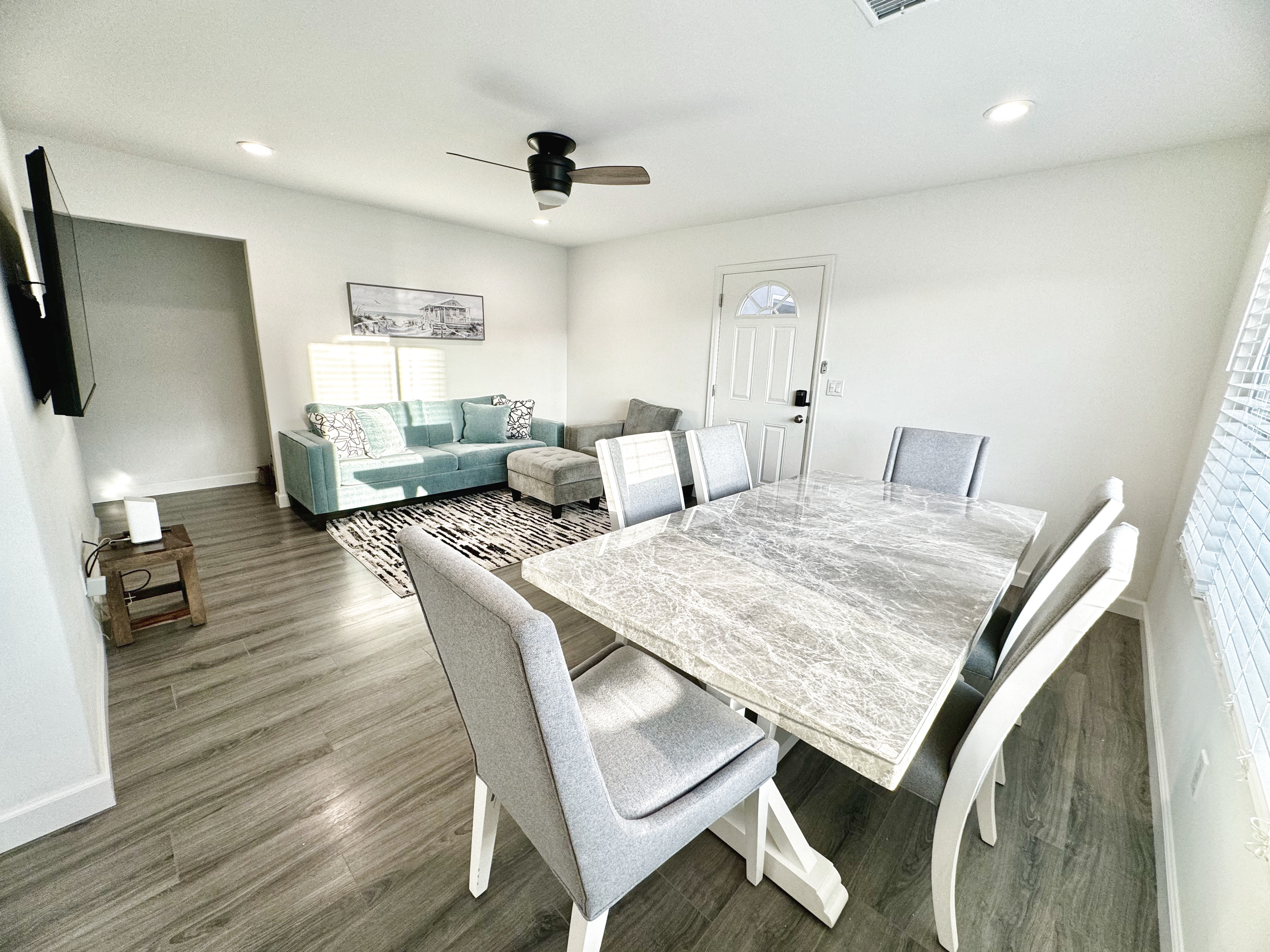 Bright Oceanside family room and dining space with coastal furnishings